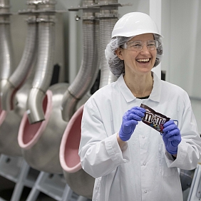 Female Mars Associate holding a packet of M&M's