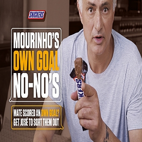 Jose Mourinho holding a SNICKERS in the brand's latest AI-powered campaign